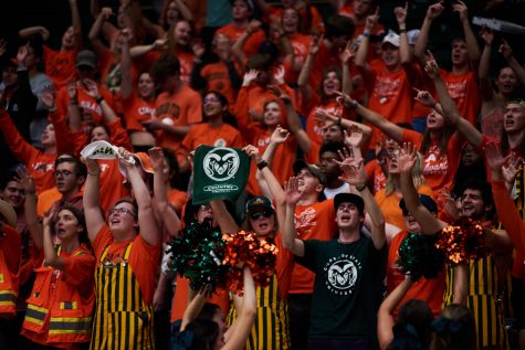 Members of the Colorado State student section cheer on the CSU volleyball team at Moby Arena Sept. 22. 