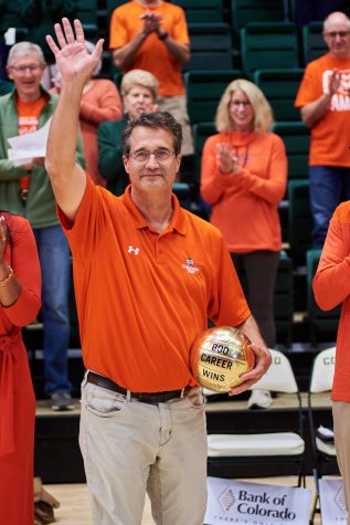 Head Coach Tom Hilbert receives a commemorative golden volleyball trophy celebrating 800 career wins prior to the Colorado State volleyball match against the University of Nevada Las Vegas Rebels Sept. 22.