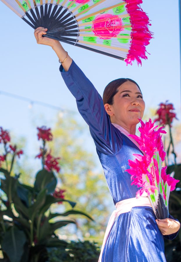 Ah Young Kim, choreography member of the First Korean Church of Fort Collins, looks toward the audience after the first performance of the traditional Korean fan dance in Old Town Square