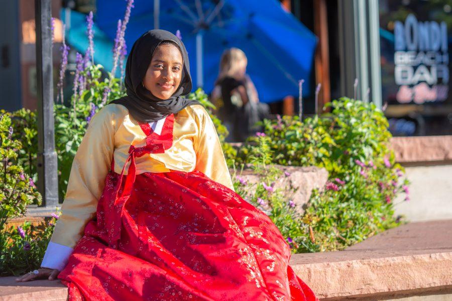 Aasha Sadiq, Colorado State University student of interior design and architecture, tries a traditional korean dress during the Korean Festival at Old Town Square