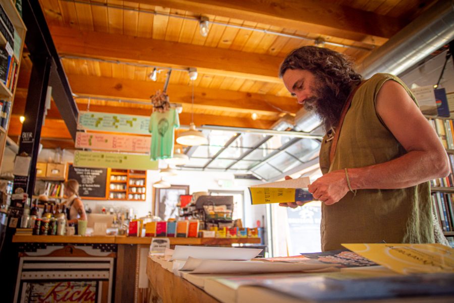 Rico Lighthouse browses the philosophy section at Wolverine Farm Publick House