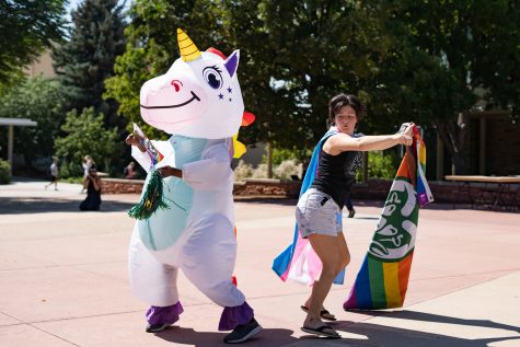 CSUnicorn Task Force dance in The Plaza with a pride flag to spread joy amid the presence of religious and anti-abortion groups