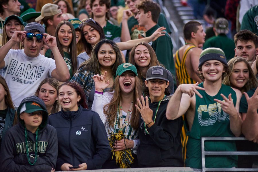 Fans dress up in green and gold for the homecoming game, Oct. 15. Colorado state fans Cheered the team till the end despite the 17-13 loss against Utah State.