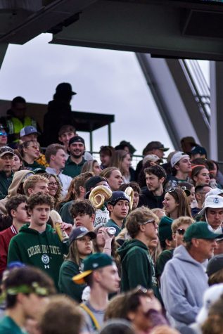 A Colorado State University fan wears ram horns