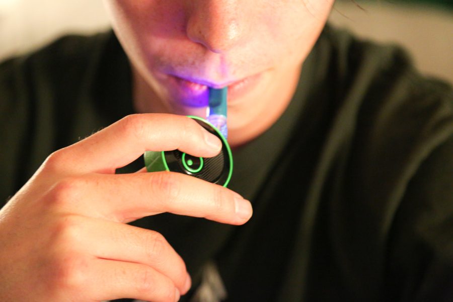 Photo Illustration of a man smoking DabLogics Strawberry Danish cannabis vape with Lookahs Snail battery.