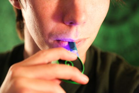 Photo Illustration of a man smoking DabLogic's Strawberry Danish cannabis vape with Lookah's Snail battery.