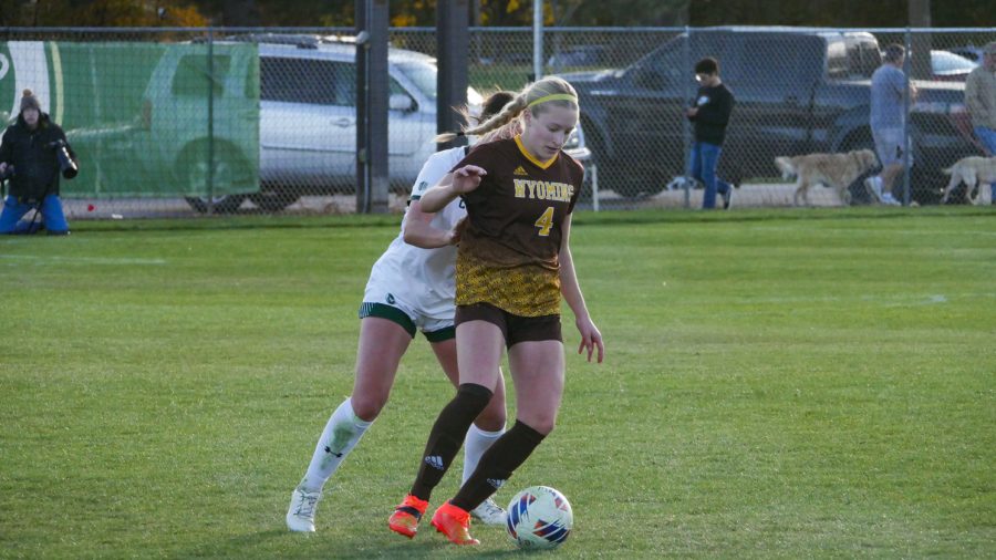 Colorado State defender Taylor Bee attempts to steal the ball from Wyoming forward Alyssa Bedard Oct 27.