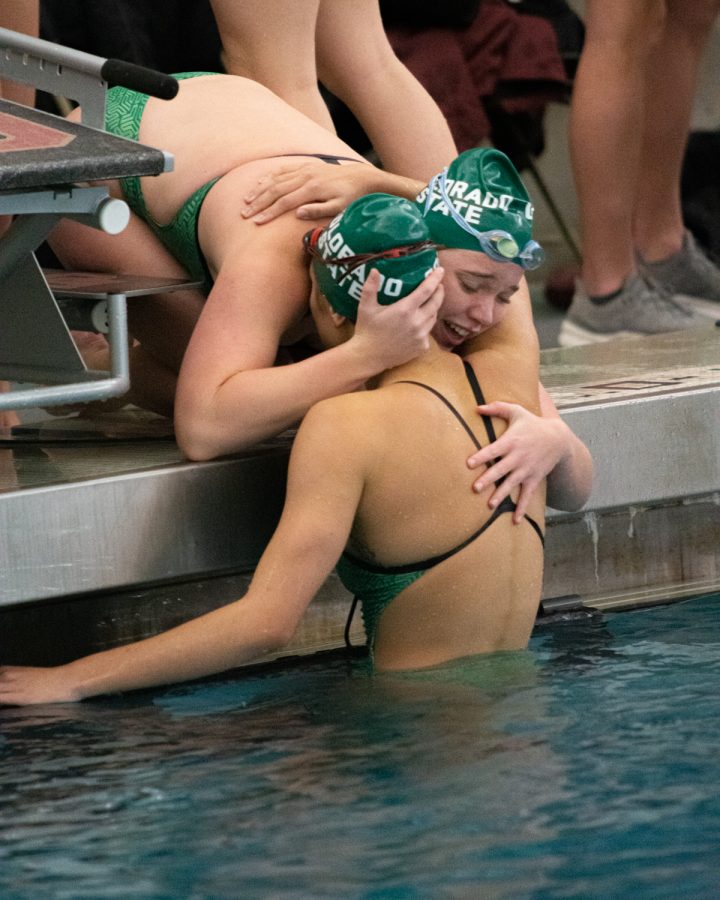 Amanda Hoffman, Colorado State University swimmer, hugs her teammate after a close win against University of Denver