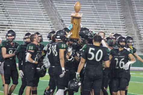 Fossil Ridge High School raises the Harmony Cup after their win against Fort Collins High School at Canvas Stadium