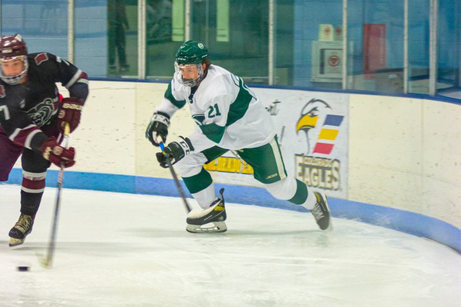 Ty Doan (21), defensemen, skates after the opposing team as they take possession of the puck