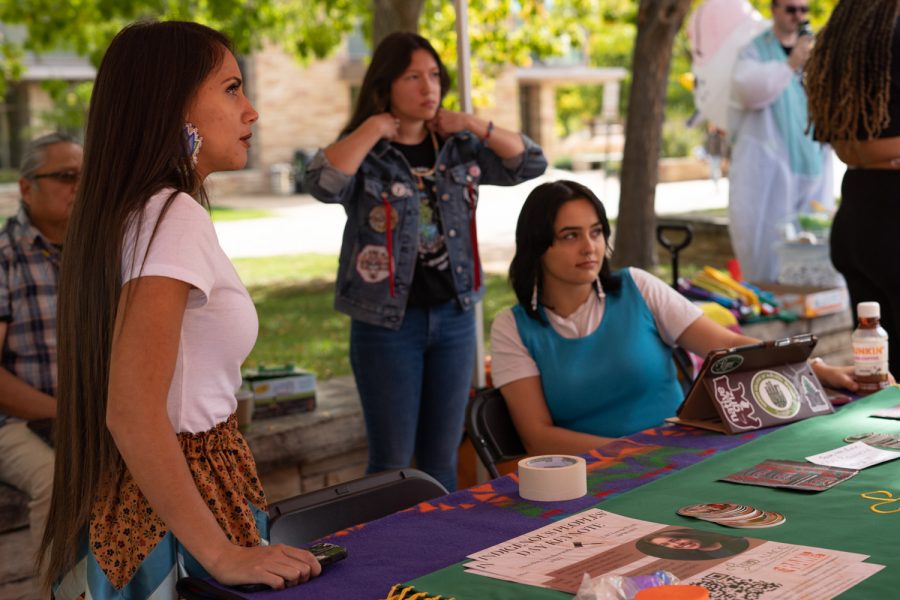 Danita Ordaz, Rasa Humeyumptewa, and Brianna Maxwell run the Native American Cultural Center booth