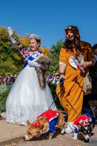 Maellie Vasicek, Chelsea Vasicek and their Corgis, Walter and Winifred, walk across the Civic Center Park in Fort Collins Colorado during the annual Tour de Corgi