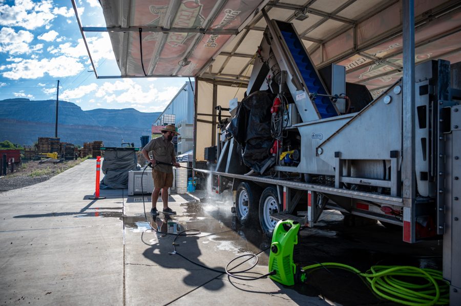 Kevin Harvey, Summit Cider Mobile Juicing Truck manager cleans the trailer before use in Palisade