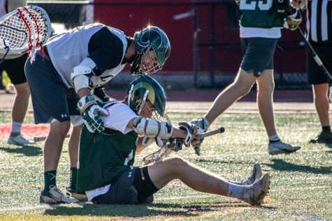 A Colorado State University lacrosse alum checks on a current playe