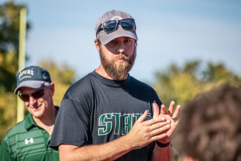 Colorado State lacrosse head coach Ryan MacDonald speaks to players during halftime of the team’s alumni game