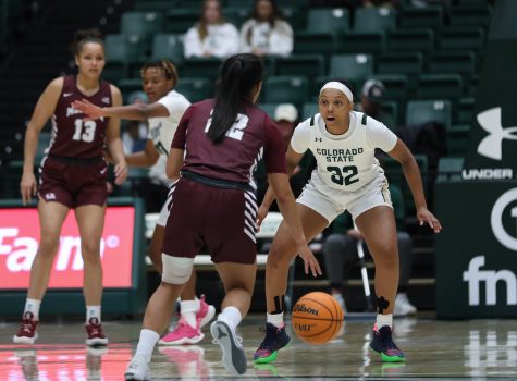 Guard Cailyn Crocker (32) takes a defensive stance as University of Montana guard Gina Marxen (22) brings the ball up the court at the Colorado State University basketball game in Moby Arena Nov. 11. The Rams beat the Lady Griz 82-58, bringing their season record to 2-0.