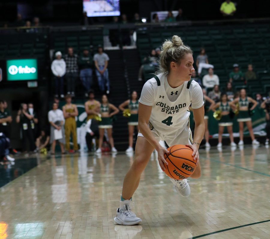 McKenna Hofschild (4), guard, looks for an alley to dribble through during the first half of the Colorado State University womens basketball game against the University of Montana at Moby Arena Nov. 11, 2022. The Rams won their second game of the season 82-58.
