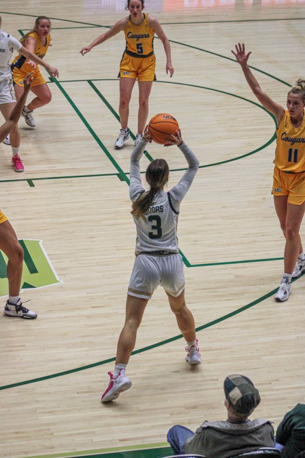 Jess Moors gets ready to pass the ball over two Colorado Christian University defenders