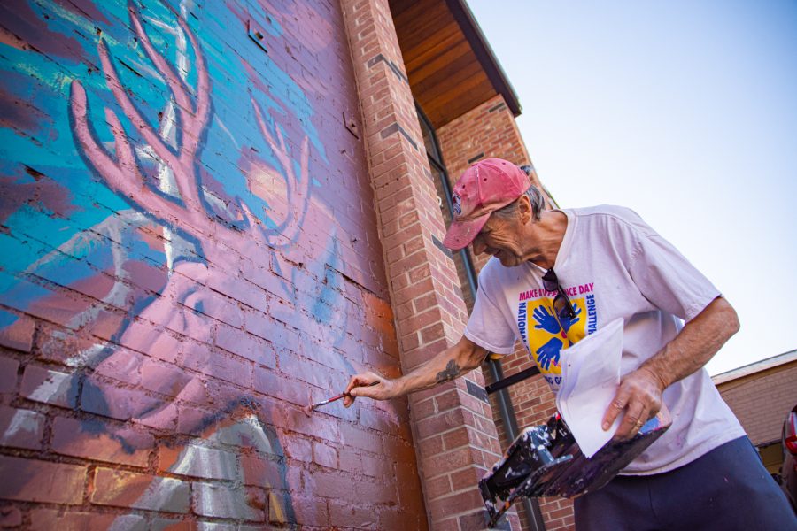 Werner Schreiber paints a mural for an organization to care for children