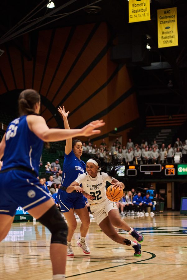 Colorado State Cailyn Crocker (32) drives into the paint as Brigham Young defender Arielle Mackey-Williams (5) attempts to stop her Nov. 8.