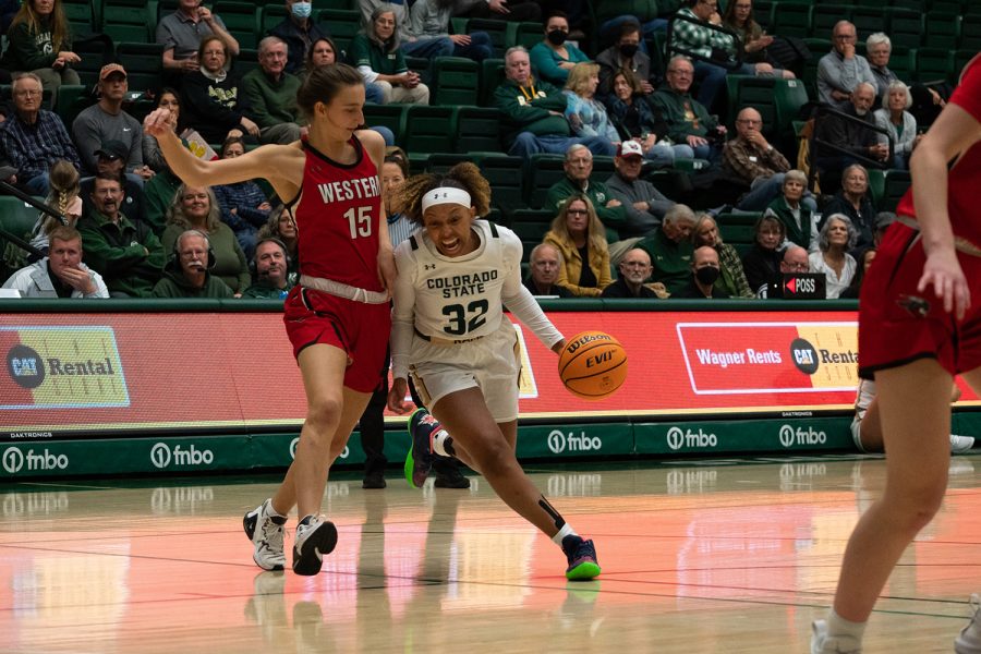 Guard Cailyn Crocker (32) dribbles past a Western State Colorado University forward at Moby Arena