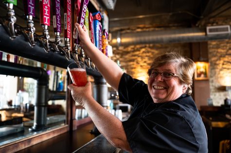 Jennifer Seiwlald pours a glass of Summit Hard Cider in Scrumpy’s Hard Cider Bar and Pub in Old Town Fort Collins