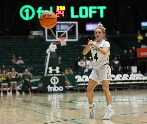 Senior guard McKenna Hofschild (4) passes the ball to her teammate during the Colorado State University game against the University of Montana in Moby Arena