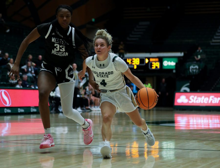 Colorado State University guard McKenna Hofschild (4) drives to the basket as Western Michigan University forward Taylor Williams (33) chases after her at Moby Arena Dec. 3, 2022. Hofschild recorded a season-high 31 points alongside nine assists in the Rams 85-65 win.