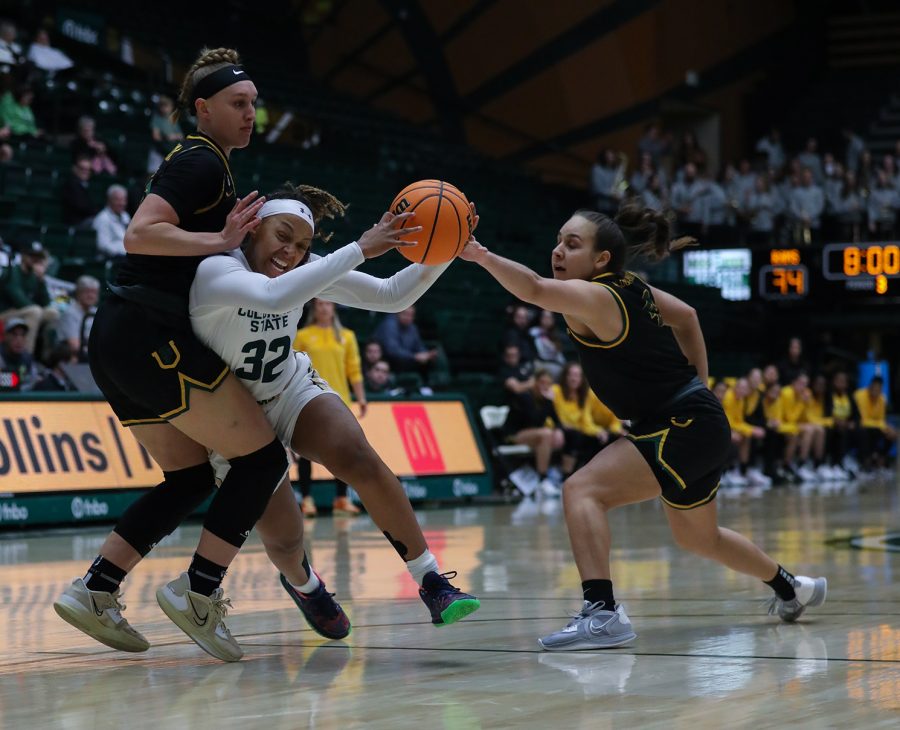 Colorado State University guard Cailyn Crocker (32) pushes past two University of San Francisco defenders to get to the basket at Moby Arena Dec. 10, 2022. The Rams lost 73-62, putting their season record at 6-4. Crocker played for nearly 35 minutes and recorded eight points and three rebounds.