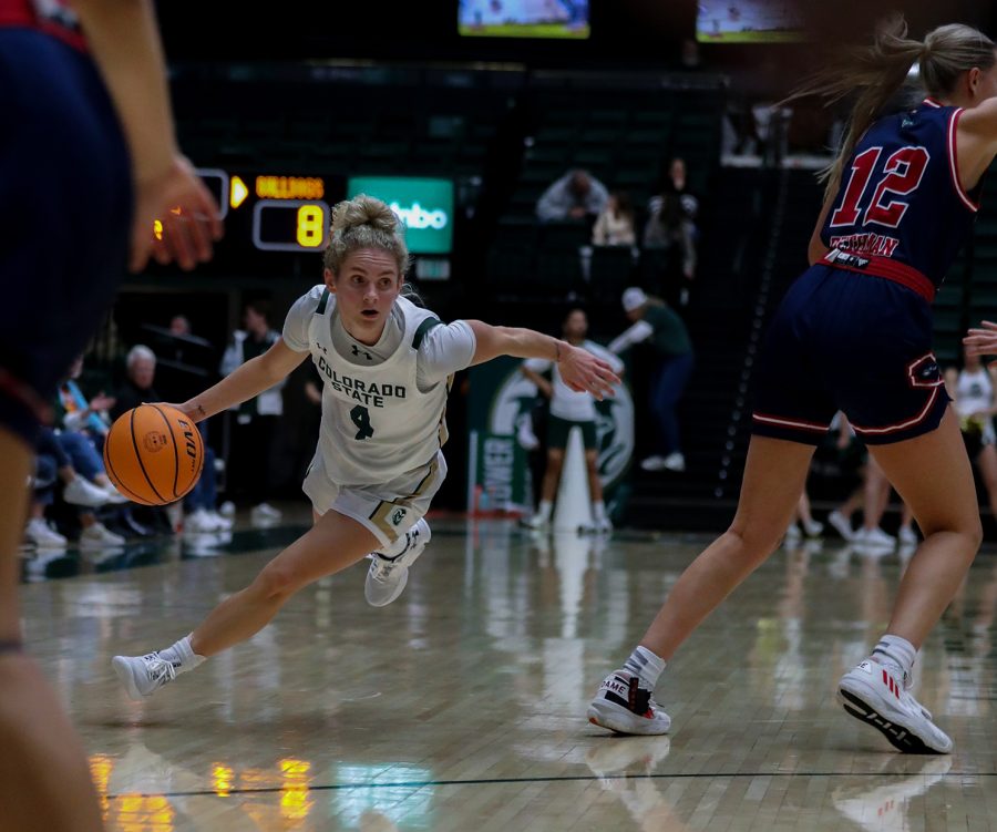 Colorado State University guard McKenna Hofschild (4) maneuvers around California State University, Fresno defenders at Moby Arena Dec. 29, 2022. The Rams won 64-58, with Hofschild contributing 29 points and eight assists.