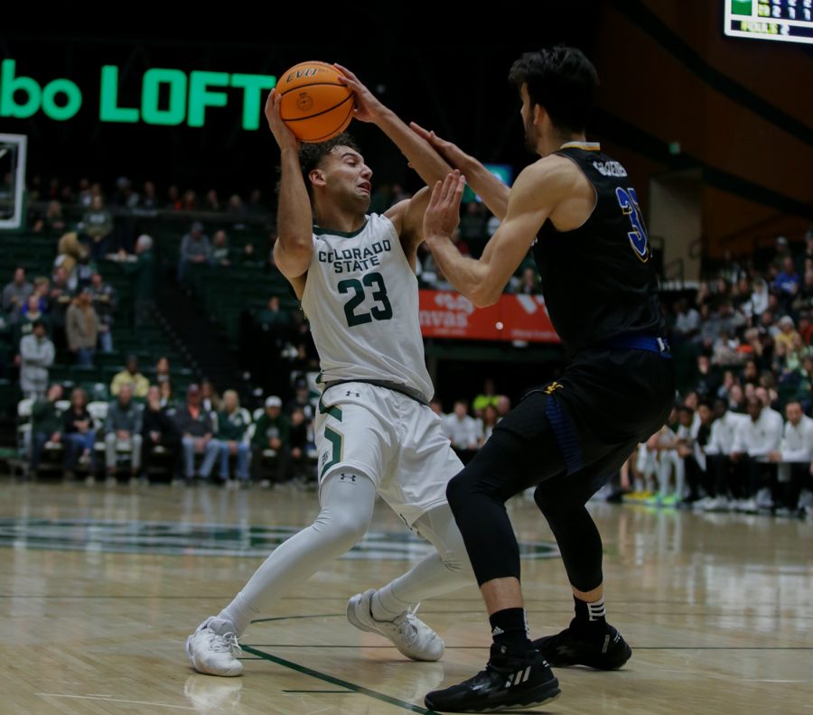 Colorado State University guard Isaiah Rivera (23) looks for a pass after being stopped on a drive by San Jose State University forward Tibet Gorener (31) at Moby Arena Dec. 31, 2022. The Rams lost 78-70, going 0-2 in Mountain West Conference play.