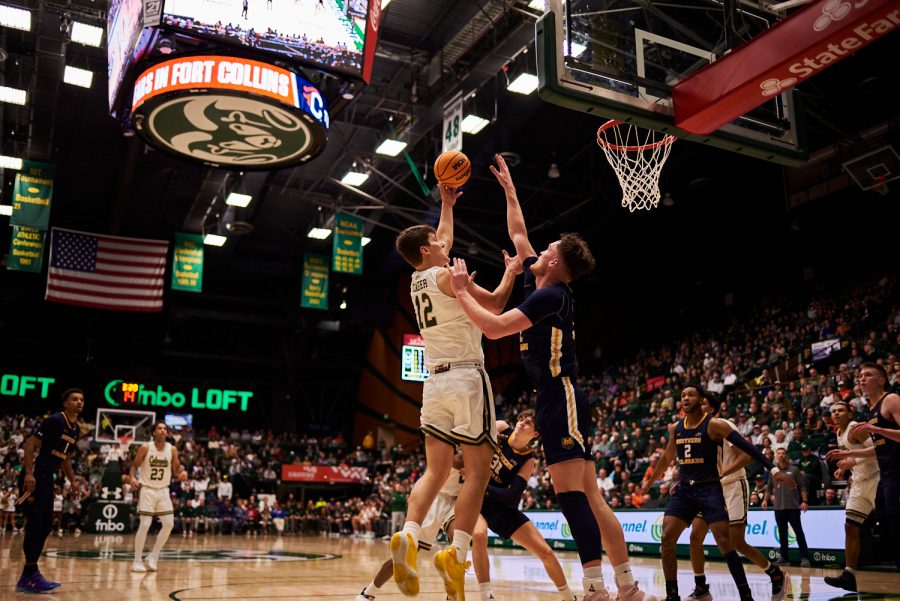 Forward Patrick Cartier (12) spins around a defender from University of Northern Colorado Dec. 3. Patrick Cartier had many more opportunities in the lane compared to previous games. “He can really finish. He can finish with both hands in the air and deliver it, but homemade some threes tonight,” Head coach Niko Medved states. Rams lost to the Bears by 5 points with a final score of 83-88.