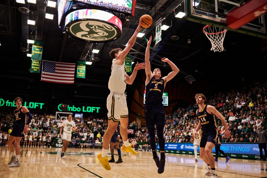 Forward Patrick Cartier (12) shoots a two pointer over a defender from University of Northern Colorado Dec. 3. Patrick Cartier had many more opportunities in the lane where his 6’ 8” height gave his a big advantage against the Bears smaller team. Rams lost to the Bears by 5 points with a final score of 83-88.