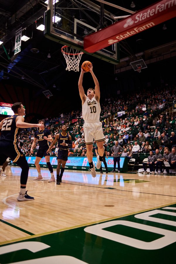 Forward James Moors (10) jumps for a dunk to start off the first half at the home game against University of Northern Colorado Dec. 3. Although recognized as a forward, Moors’ athletic build allows him to work the paint and fill roles of a center.