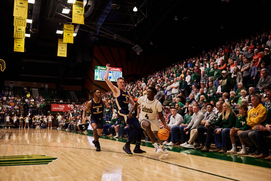 Guard Isaiah Stevens (4) dribbles past a defender at the home game against University of Northern Colorado Dec. 3. Stevens had the second highest points scored with 20 points. Rams lost to the Bears by 5 points with a final score of 83-88.
