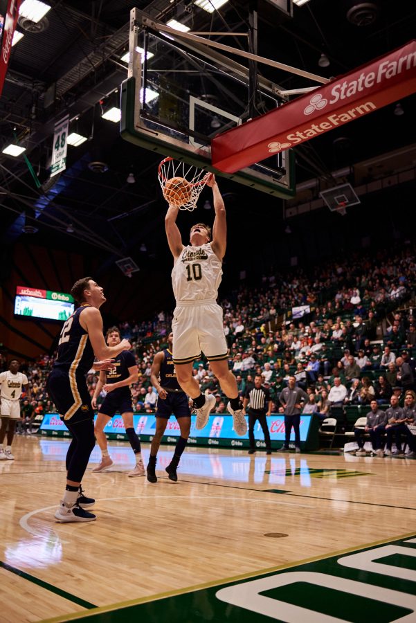Forward James Moors (10) dunks to start off the first half at the home game against University of Northern Colorado Dec. 3. Although recognized as a forward, Moors’ athletic build allows him to work the paint and fill roles of a center. Rams lost to the Bears by 5 points with a final score of 83-88.