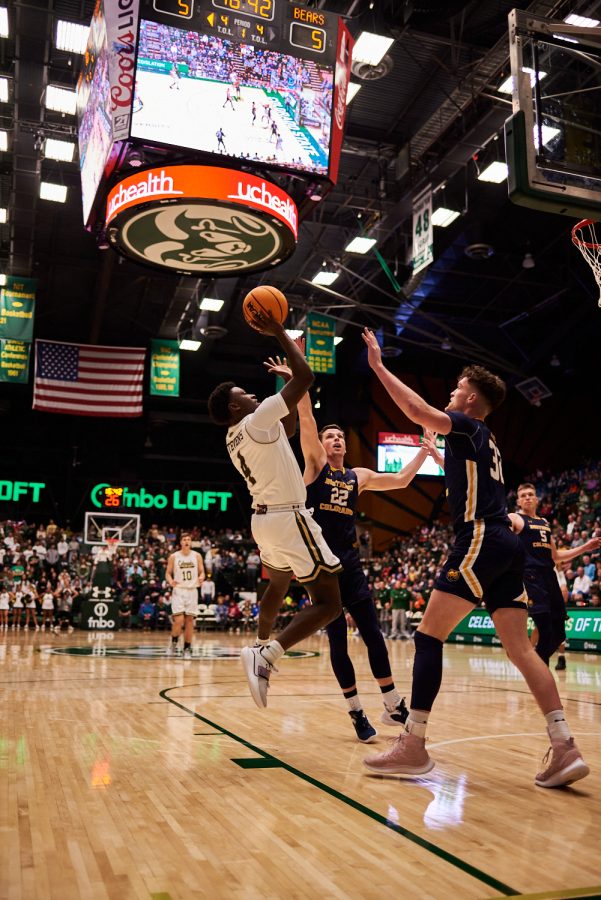 Guard Isaiah Stevens (4) shoots a tough shot through two University of Northern Colorado defenders Dec. 3. This game marks Steven’s second game since the return from his injury. Despite the recent injury, Stevens scored 20 points against the Bears making his the second highest scorer on the team this game. Rams lost to the Bears by 5 points with a final score of 83-88.
