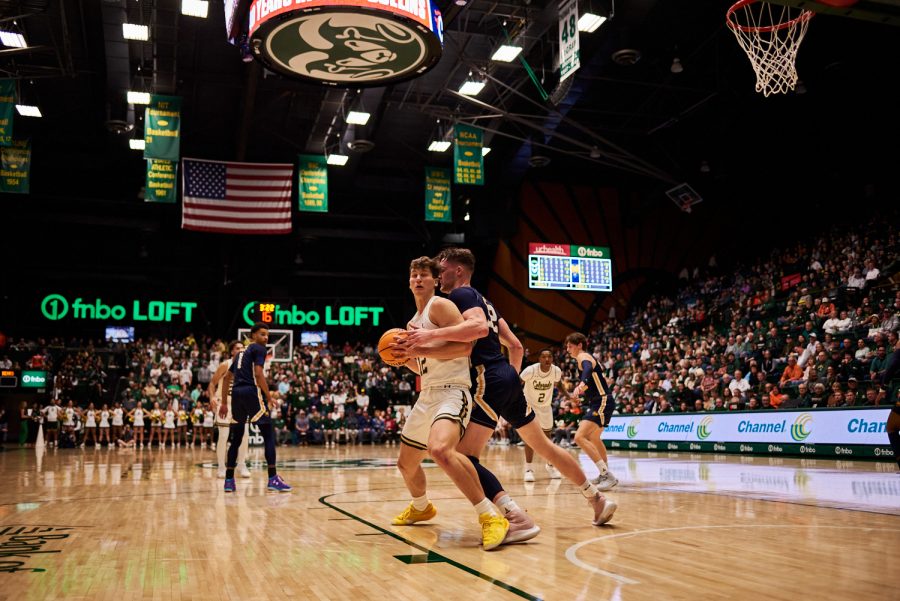 Forward Patrick Cartier (12) spins around a defender from University of Northern Colorado Dec. 3. Patrick Cartier had many more opportunities in the lane compared to previous games. “He can really finish. He can finish with both hands in the air and deliver it, but homemade some threes tonight,” Head coach Niko Medved states. Rams lost to the Bears by 5 points with a final score of 83-88.