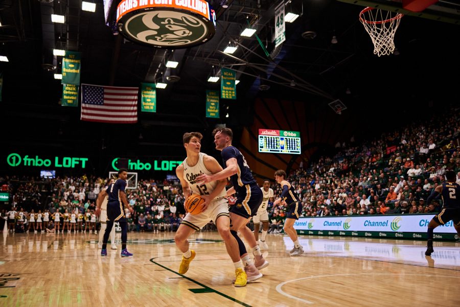 Forward Patrick Cartier (12) spins around a defender from University of Northern Colorado Dec. 3. Patrick Cartier had many more opportunities in the lane compared to previous games. “He can really finish. He can finish with both hands in the air and deliver it, but homemade some threes tonight,” Head coach Niko Medved states. Rams lost to the Bears by 5 points with a final score of 83-88.
