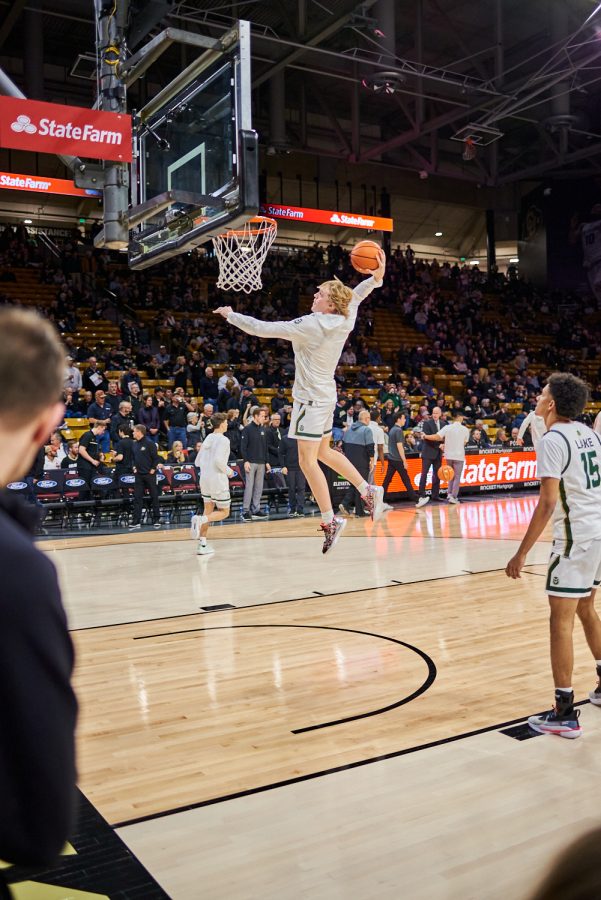 Guard Jackson Payne (11) dunks while warming up at the University of Colorado Boulder away basketball game Dec. 8. Colorado State University was losing at halftime with a score of 30-38 and went on to lose at a final score of 65-93.
