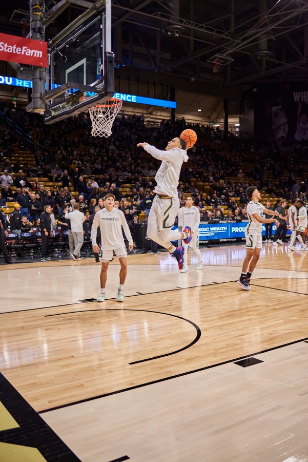 Guard John Tonje (1) dunks while warming up at the University of Colorado Boulder away basketball game Dec. 8. Colorado State University was losing at halftime with a score of 30-38 and went on to lose at a final score of 65-93.