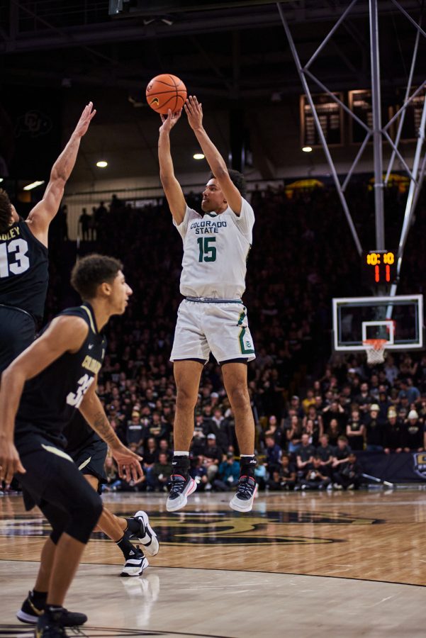 Guard Jalen Lake (15) shoots a two pointer over a defender at the University of Colorado Boulder away basketball game Dec. 8. Lake shot a 50% for two pointers made at the game. Colorado State University went on to lose with a final score of 65-93.