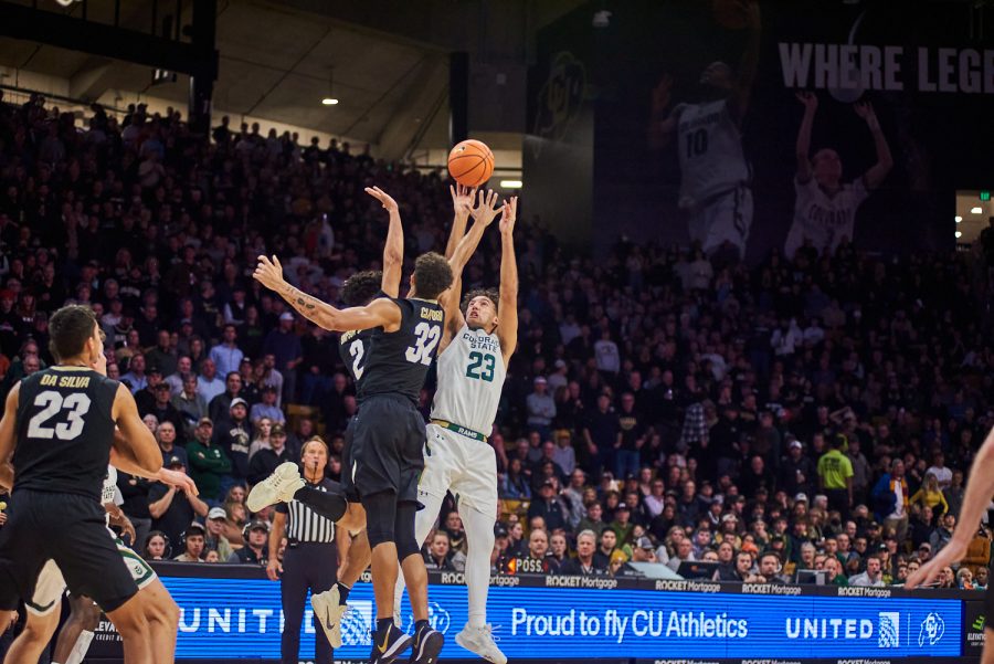 Guard Isaiah Rivera (23) shoots a two pointer over two defenders at the University of Colorado Boulder away basketball game Dec. 8. Lake shot a 33% for two pointers made at the game. Colorado State University went on to lose with a final score of 65-93.