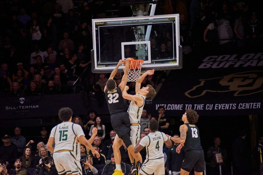 Forward Patrick Cartier (12) gets dunked on at the University of Colorado Boulder away basketball game Dec. 8. Cartier showed a strong defensive game in previous games and has continued to hold a strong defensive reputation. Colorado State University went on to lose with a final score of 65-93.