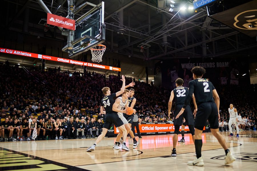 Forward James Moors (10) looks for a pass after being double teamed in the paint at the University of Colorado Boulder away basketball game Dec. 8. Moors passed to Guard Isaiah Rivera (23) who made the three point shot. Colorado State University went on to lose with a final score of 65-93.