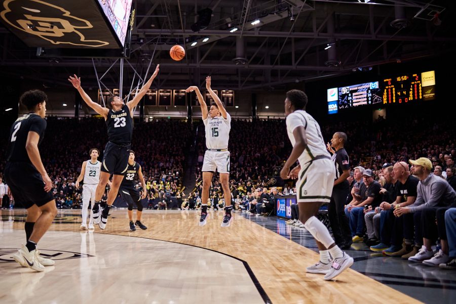 Guard Jalen Lake (15) shoots a three pointer over a defender at the University of Colorado Boulder basketball game