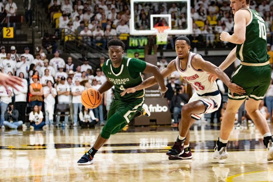 Colorado State guard Issaiah Stevens (4) dribbles the ball past Wyoming guard Xavier DuSell (53) Jan. 21.