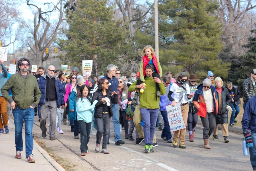 A participant holds a child on their shoulders during the Martin Luther King Jr. Day march Jan. 16. The Fort Collins community marched together to honor Martin Luther King Jr.