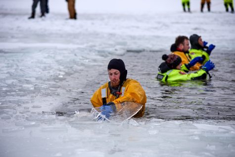 A member of the Larimer County Dive Rescue Team removes sharp ice chunks from the area set for the Polar Plunge into Horsetooth Reservoir Jan. 21. The LCDRT oversaw the safety of the runners participating in the polar plunge.
