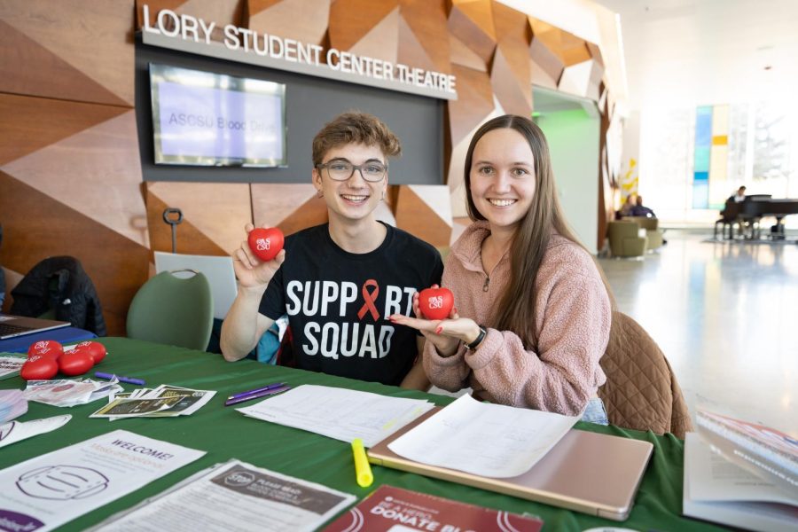 Alex Silverhart, ASCSU Director of Health and Wellness, and Amber Wright, a member of the ASCSU Supreme Court, sit ready to check blood donors in at the blood drive they helped to organize in collaboration with PreMedica Club at the Lory Student Center Theatre